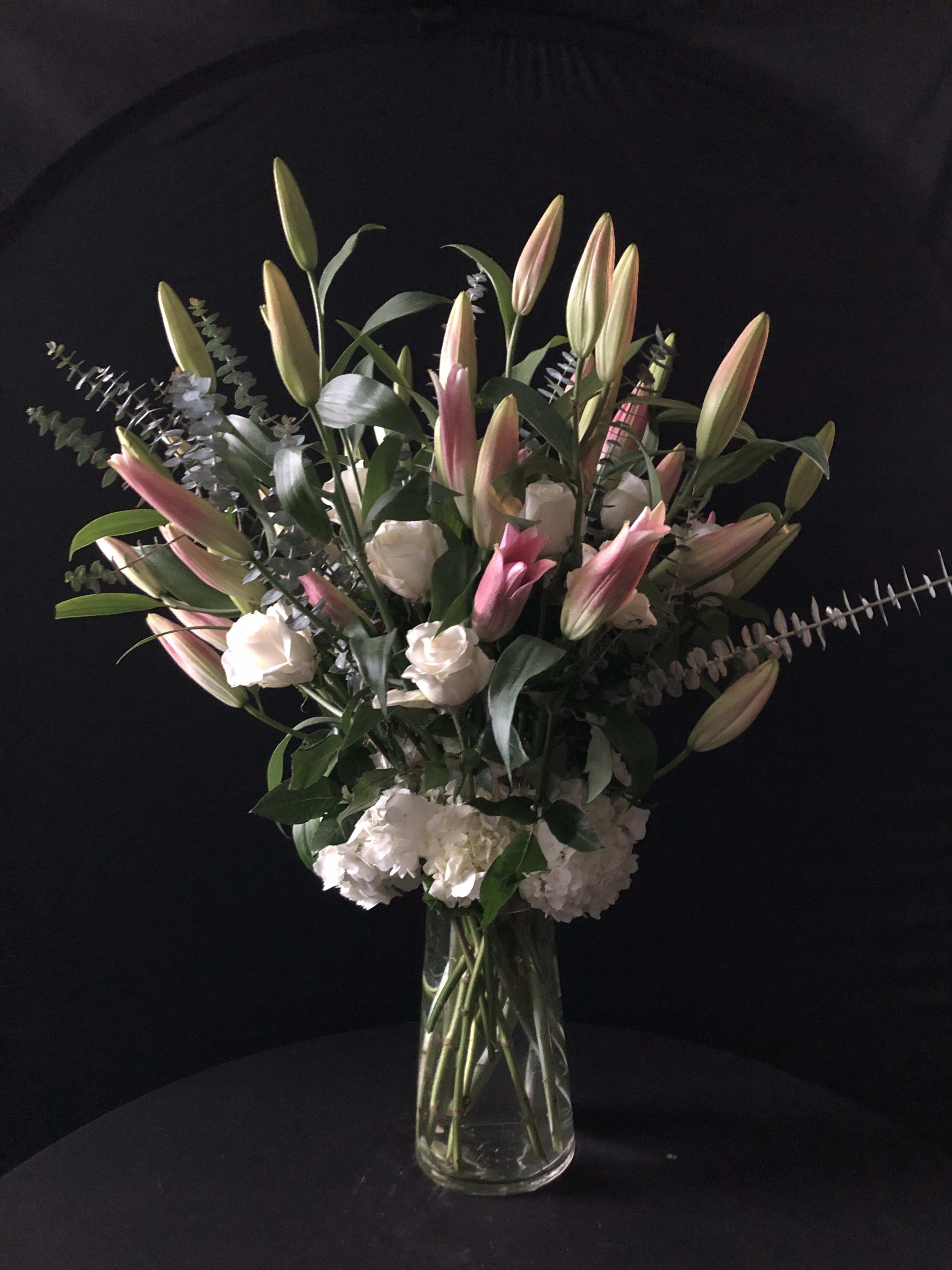 White Roses and Lilys. - This tall arrangements is composed of white hydrangeas, roses and lilies.    We will contact you if not available.   Same day delivery must be made by 1 or please call us 512-291-3536. We will do our best to make it happen, lets talk!  ***All designs subject to changes because of flower season and availability. Please let us know if there is something in this design you must have****      