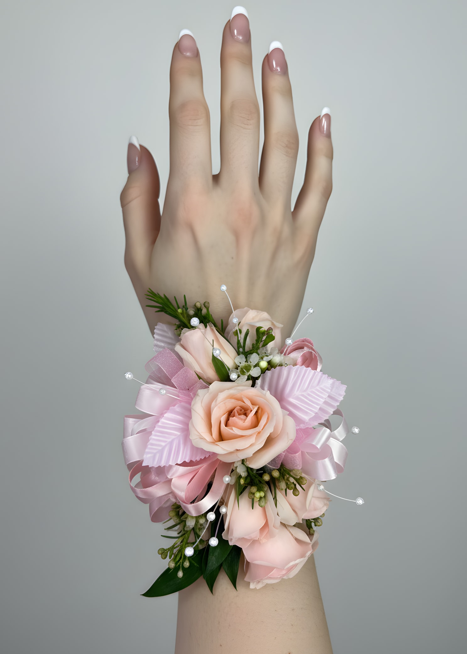Pink Rose Corsage - A classic pink rose corsage complements any outfit. Perfect for prom, formals, and weddings. Attached to a wrist bracelet for easy and comfortable wear. If you require customized colors, please specify your request clearly when placing your order. In the event that the requested color is unavailable, we will contact you to discuss alternative options.  Please note that customized color requests are subject to a $15 upcharge.