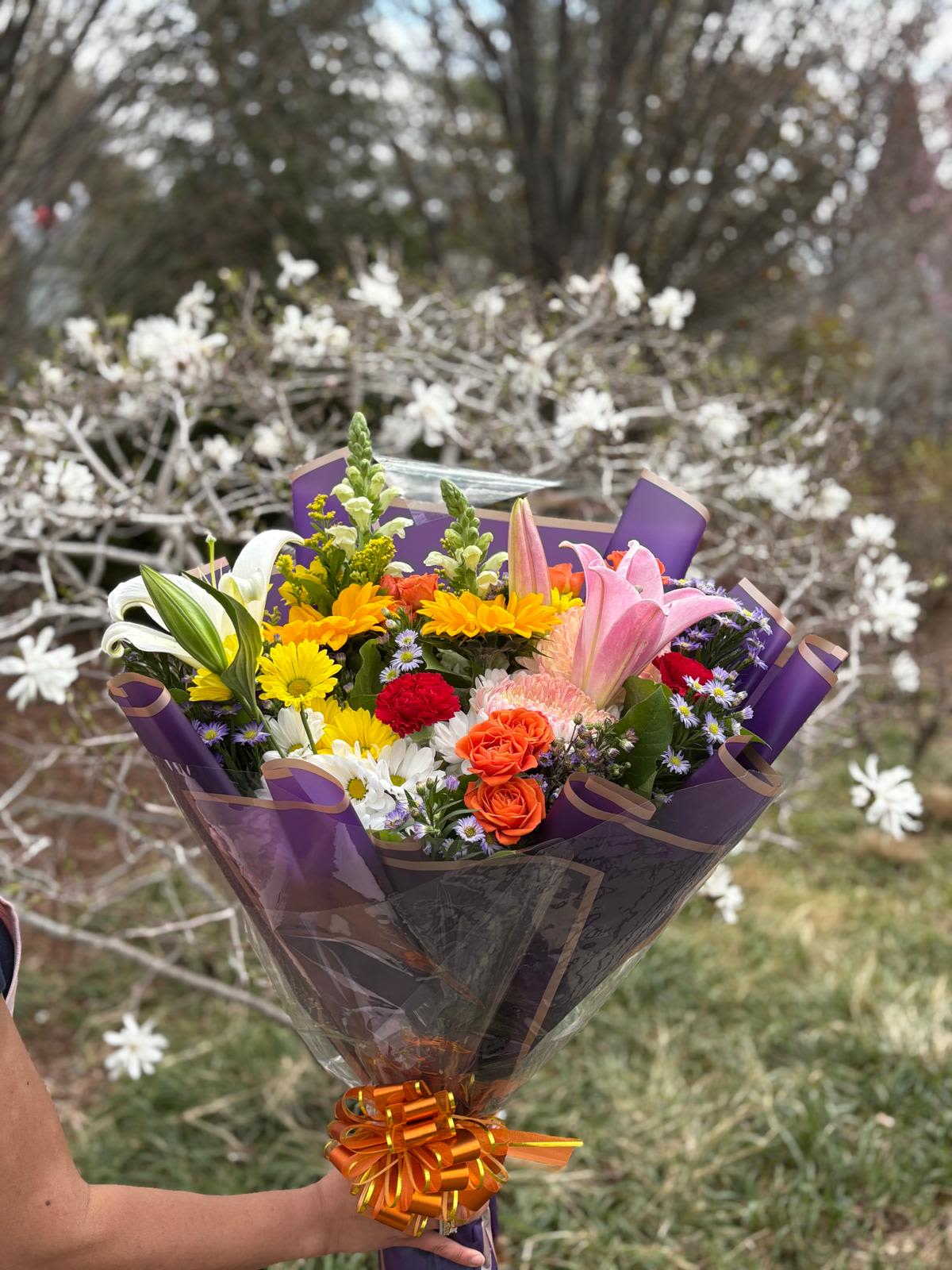 Floral Paradise - A cheerful bouquet with a mix of seasonal flowers. Designed, packaged, and ready to take its place in your favorite vase or to surprise that special someone.