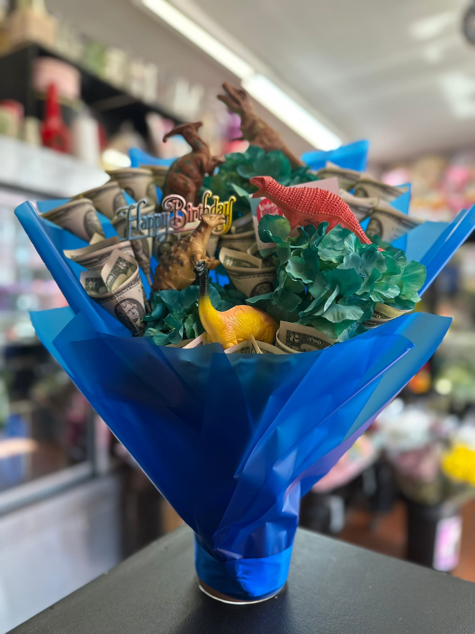 Dino Money Unique Bouquet - For any dino or animal lovers this is a unique arrangement made for those that are fans of prehistoric creatures and money!