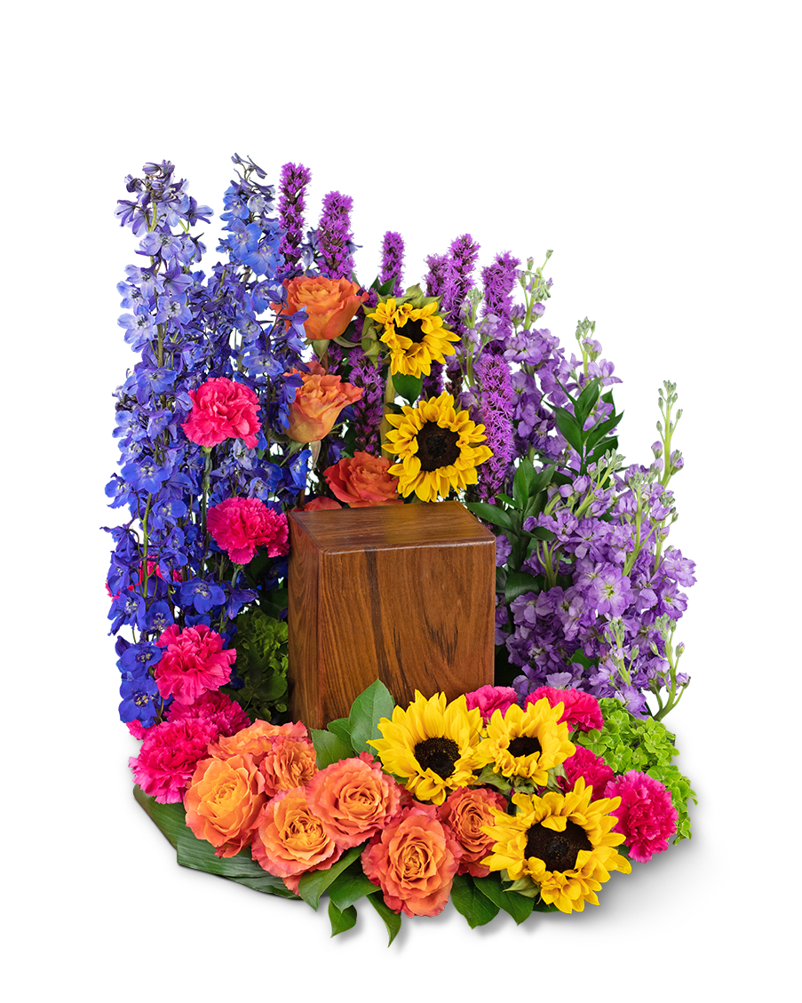 Treasured Memories Urn Surround - Sympathy flowers are a meaningful way to celebrate the life of the deceased, and forever treasure the memories you made together. Our Treasured Memories Casket Spray features Free Spirit roses, sunflowers, bright pink carnations, liatris, blue delphinium, green hydrangea, stock, and premium foliage. Funeral flowers bring healing in many ways, they serve as a memorial to honor the one that we lost, all while providing comfort to the friends and family left behind.