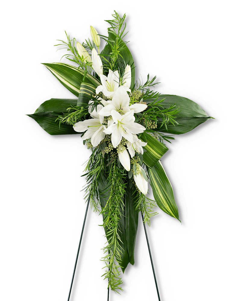 Tall cross-shaped arrangement of white lilies and lush green leaves on an easel stand