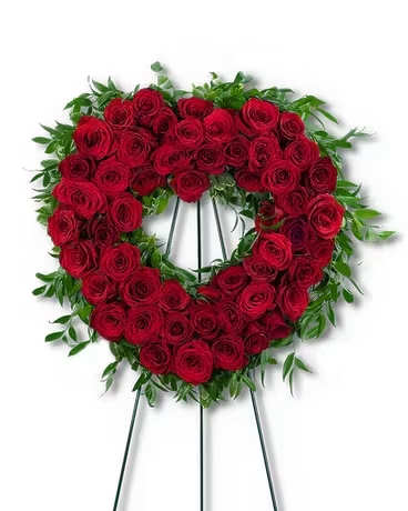 Abiding Love Heart  - Our Abiding Love Heart is a classic and beautiful choice for funeral flowers or a celebration of life ceremony. This standing spray features beautiful red roses and a variety of premium foliage, artfully designed to be displayed on a heart shaped easel. Red roses symbolize respect, love, and courage in a sympathy design. Funeral flowers are a meaningful way to celebrate the life of the deceased, while providing comfort to the friends and family left behind.