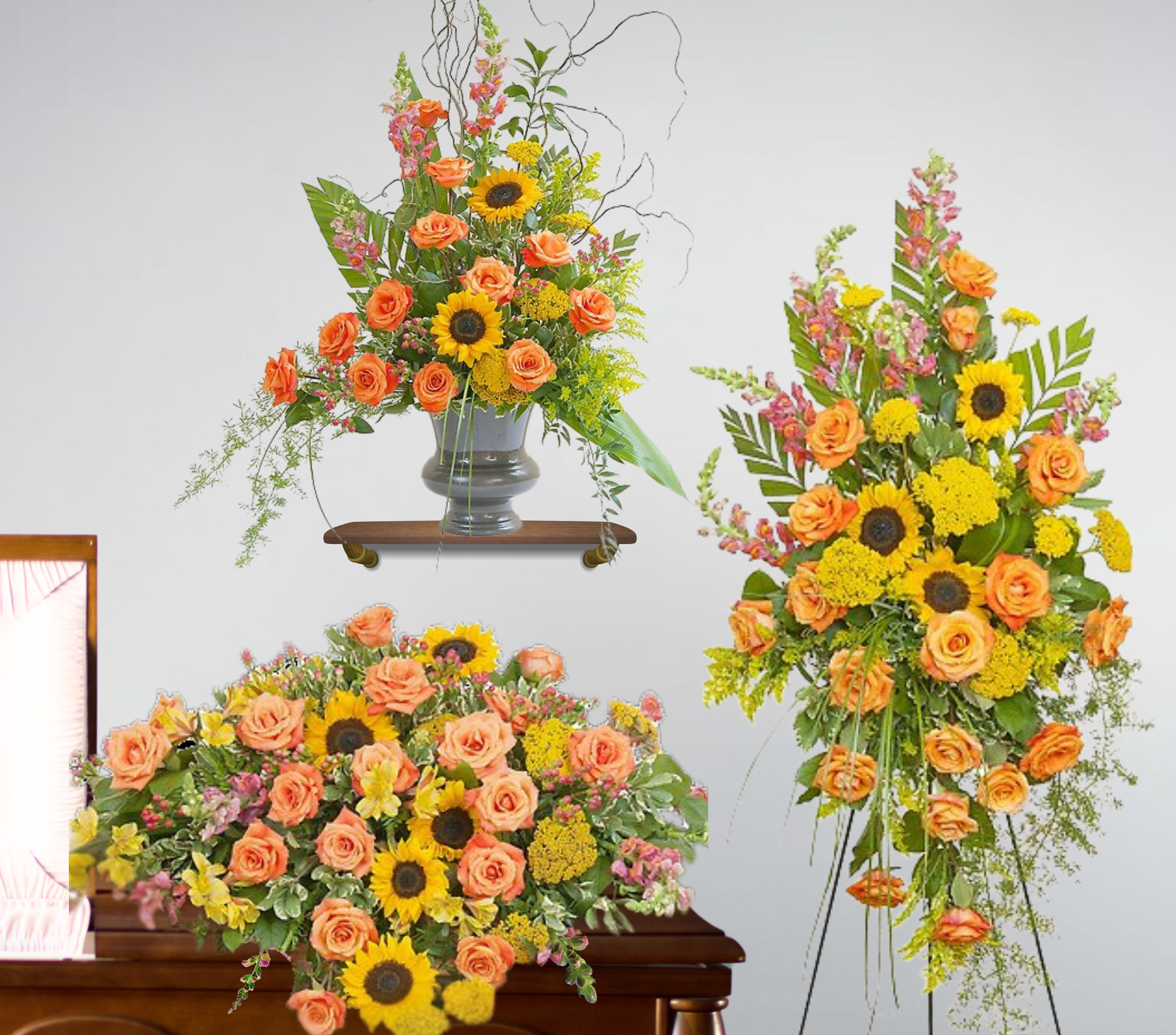 Set of orange rose and yellow sunflower sympathy arrangements with casket spray, easel spray, and urn piece.