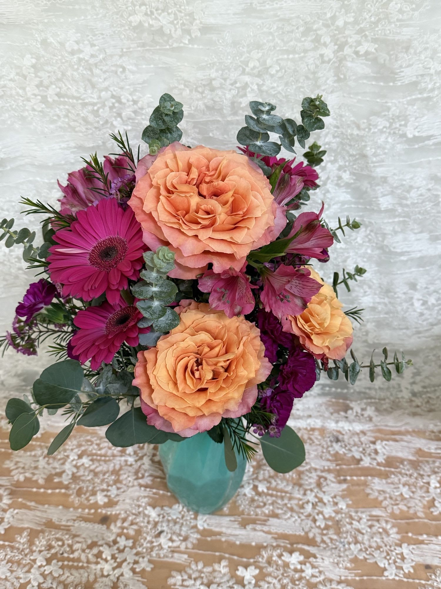 Radiant - Garden roses, Gerber daisies, mini carnations and alstroemeria with eucalyptus.