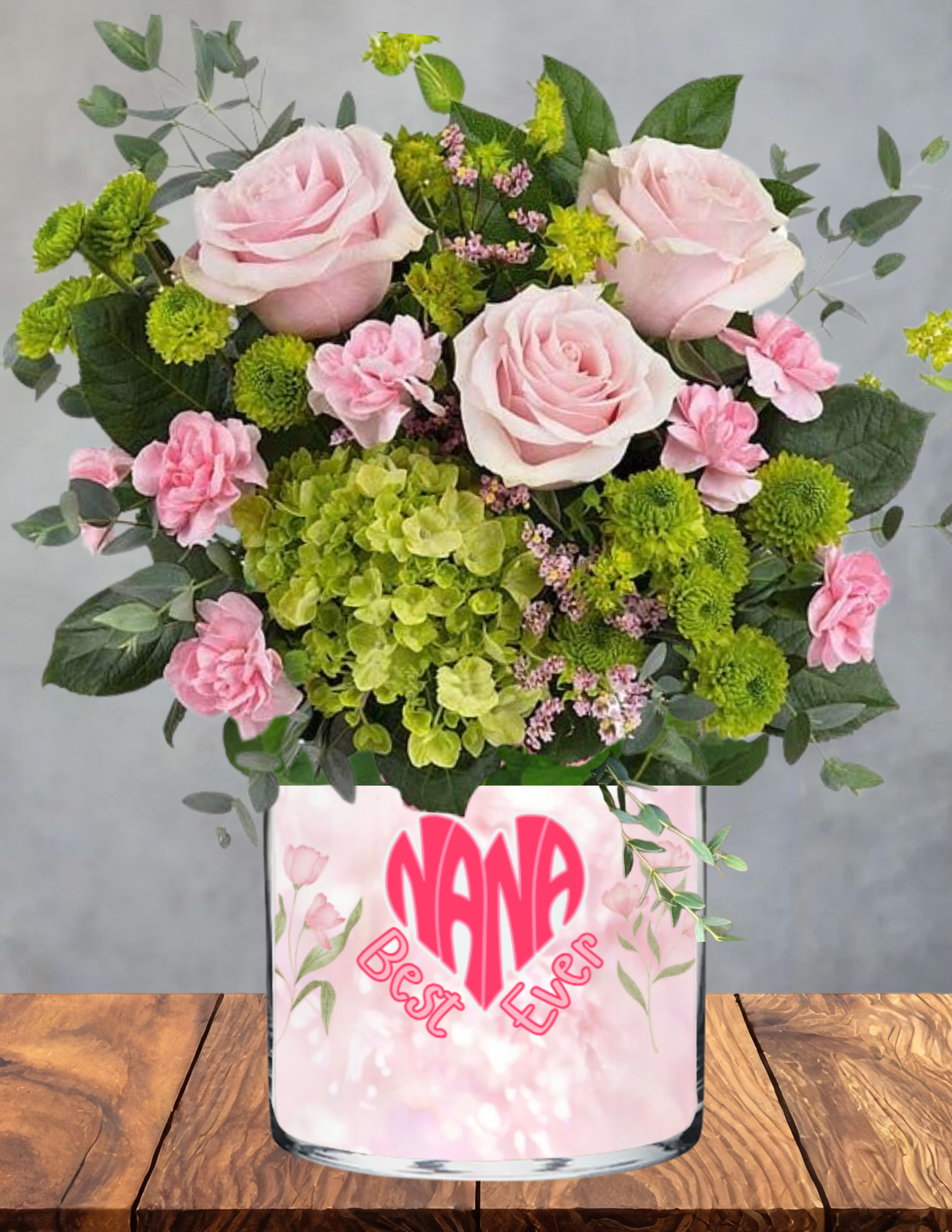 Nanas sweet meadow - A gentle garden of love, gathered just for the one who makes every moment sweeter.  Nana’s Sweet Meadow blends blush roses, soft pink carnations, fresh green hydrangeas, and cheerful button blooms into a pastel‑kissed arrangement that feels calm, comforting, and full of affection. Each flower adds its own whisper of gratitude — for her kindness, her warmth, and the way she makes family feel like home.  Nestled among the blooms is a charming heart accent celebrating her as the “Best Ever,” a keepsake she’ll treasure long after the flowers have faded. Presented in a playful, pastel‑patterned vase made just for Nana, this design radiates joy, tenderness, and that unmistakable grandmotherly love.  A perfect way to remind her how cherished she truly is.