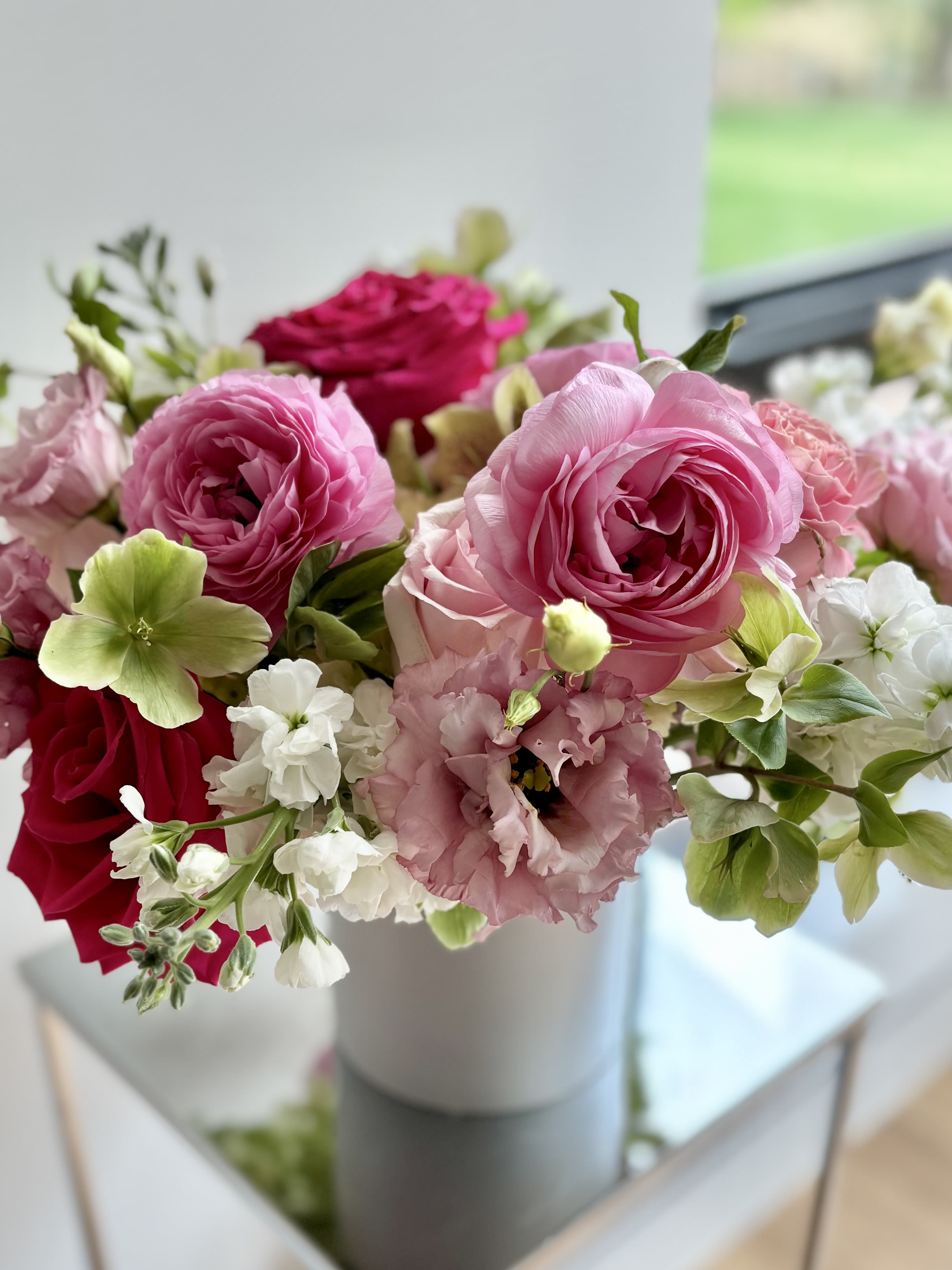 Cherry Blossom - A lovely flower arrangement filled with blooming love. A mix of premium flowers in the pink &amp; white color palette, usually with roses, ranunculus, anemone, hellebore, stock, and lisianthus. 