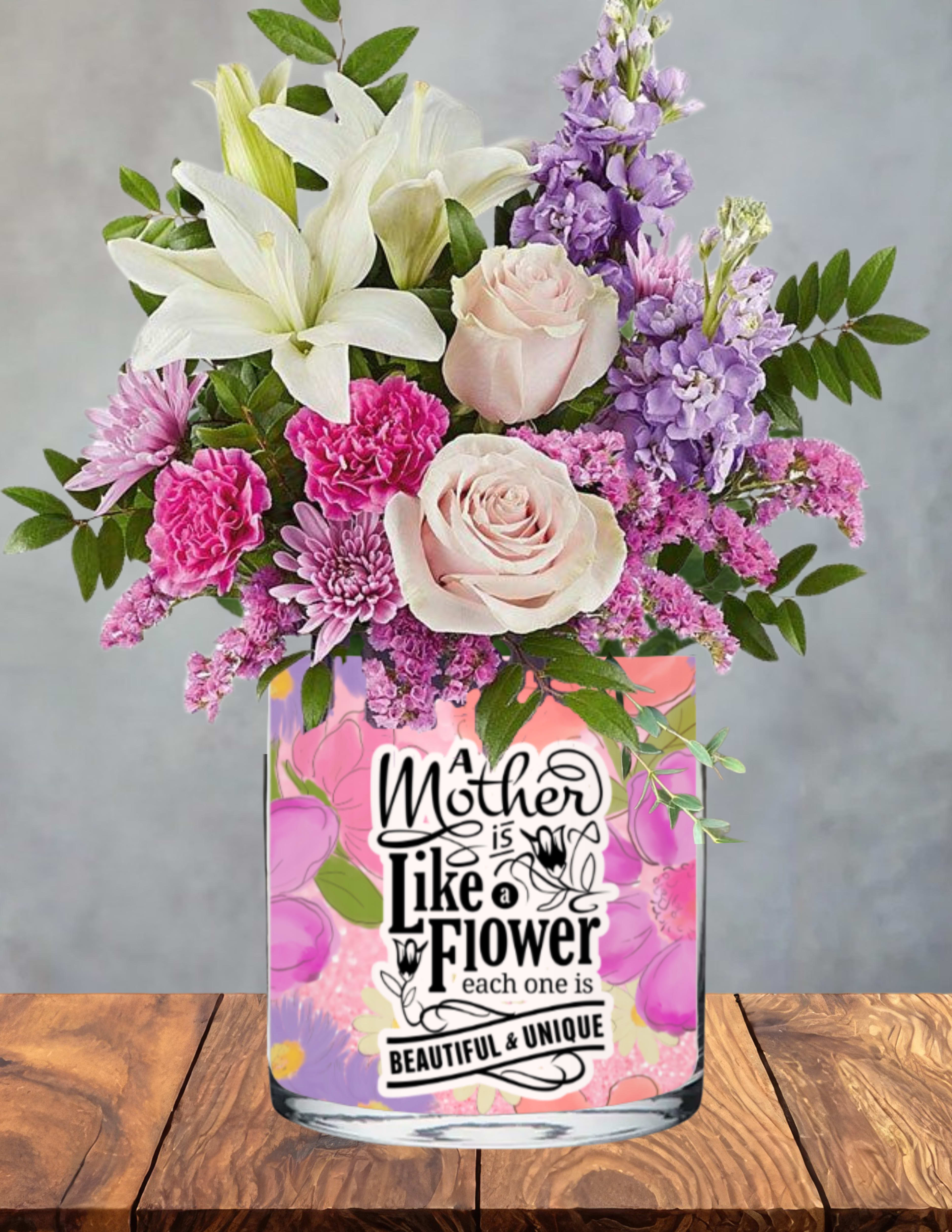 Moms lavender garden - A soft, calming garden scene designed to honor her quiet strength and timeless beauty.  Mom’s Lavender Meadow gathers white lilies, blush roses, lavender stock, pink carnations, and soft chrysanthemums into a soothing blend of pastel blooms. The palette feels like a peaceful walk through a spring meadow — airy, elegant, and full of tender warmth. Each flower offers its own note of gratitude, celebrating the love, patience, and grace she brings to every day.  Presented in a floral‑patterned vase printed with the sentiment “A Mother is Like a Flower — Each One is Beautiful &amp; Unique,” this arrangement becomes both a heartfelt tribute and a keepsake she’ll treasure. Its gentle colors and lush textures create a design that radiates serenity, appreciation, and the quiet joy of honoring Mom.  A beautiful choice for the mother whose presence feels like calm in full bloom.