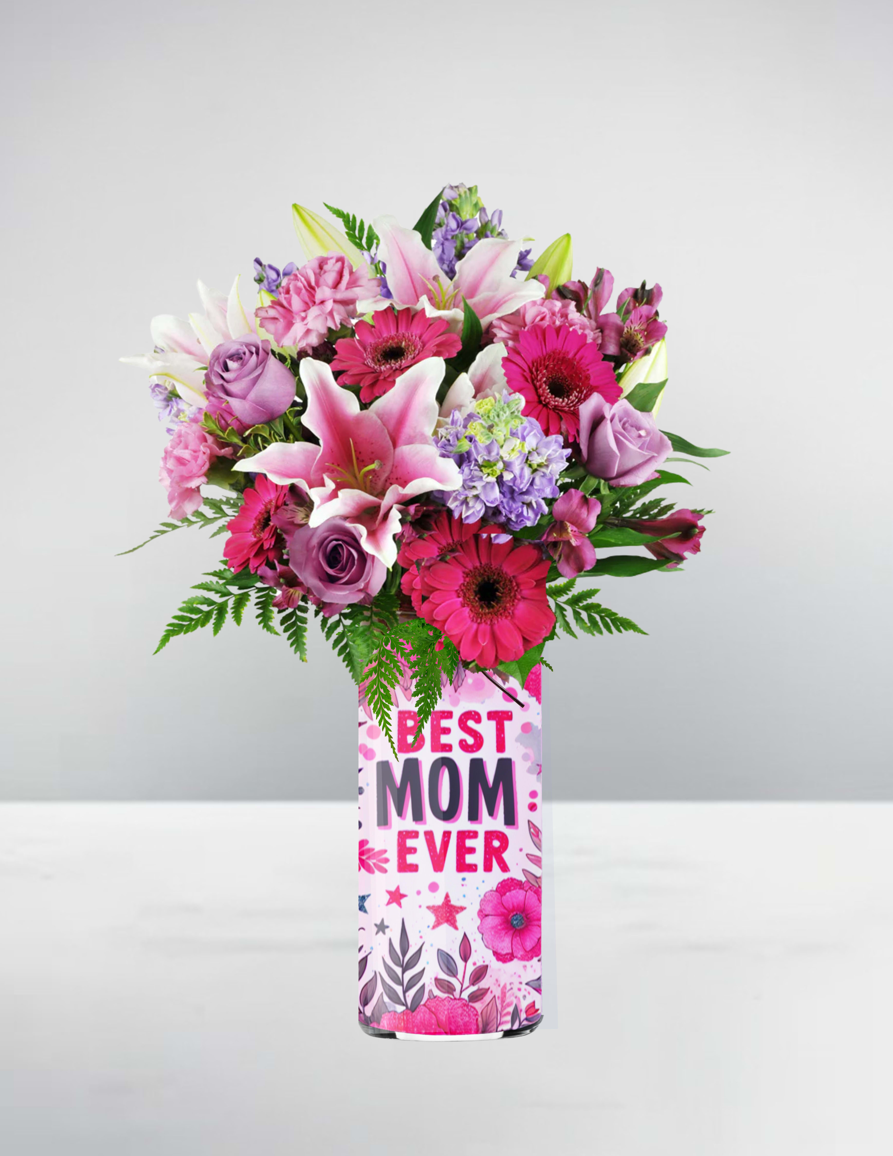 Tall pink and purple bouquet with lilies, roses, and gerbera daisies in a Best Mom Ever vase