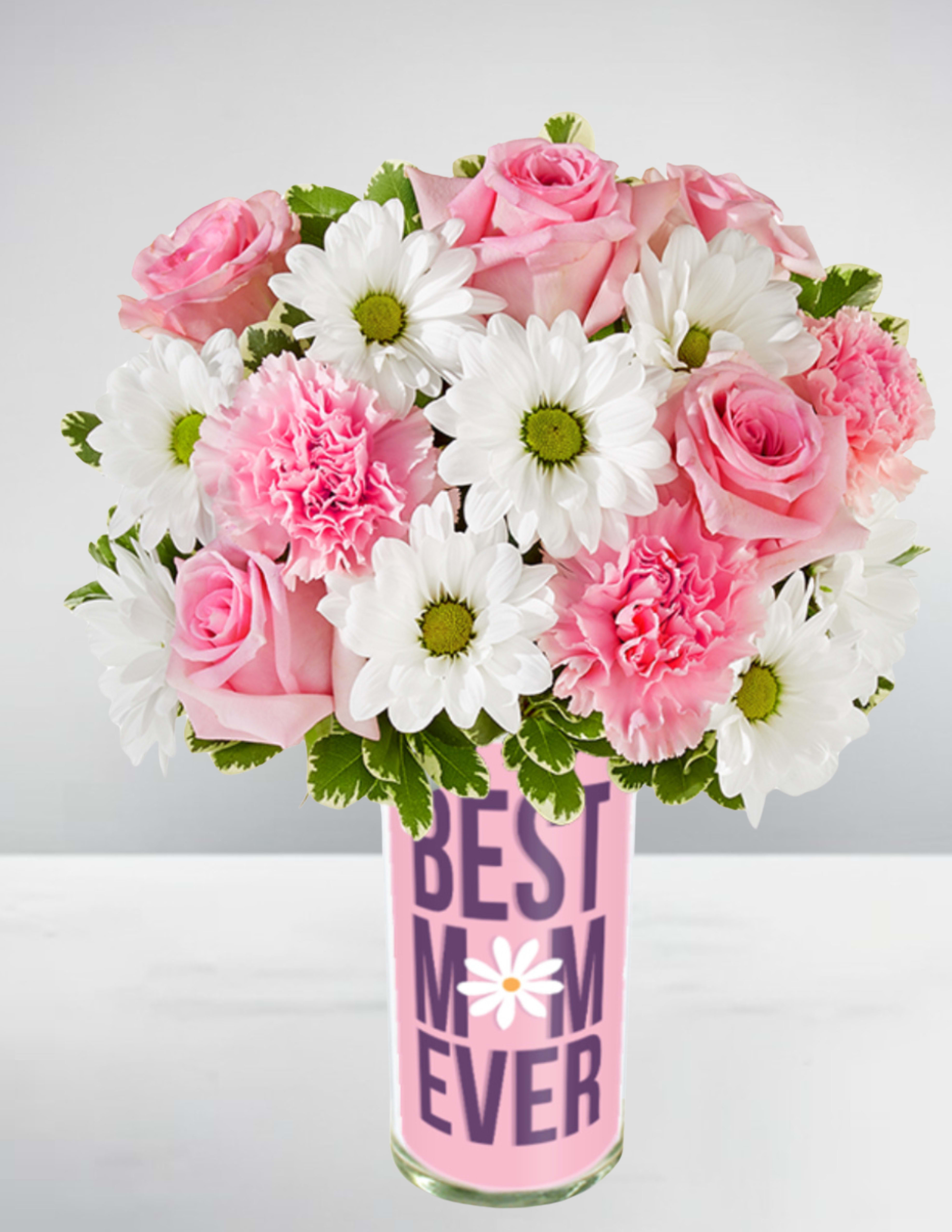 Pink roses, pink carnations, and white daisies in a tall vase labeled "Best Mom Ever".