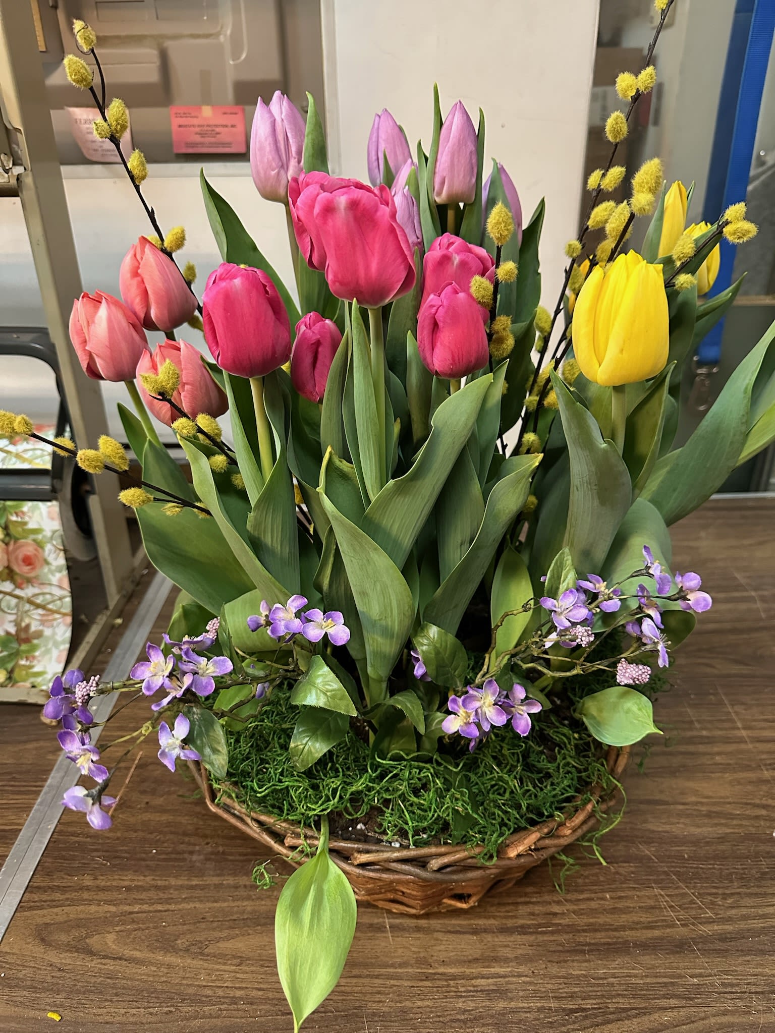 Assorted  Bulb Plant Basket - Bring the magic of spring indoors with a custom Bulb Plant Basket. These pre-planted arrangements offer a "garden in a basket" experience, featuring a curated mix of seasonal favorites