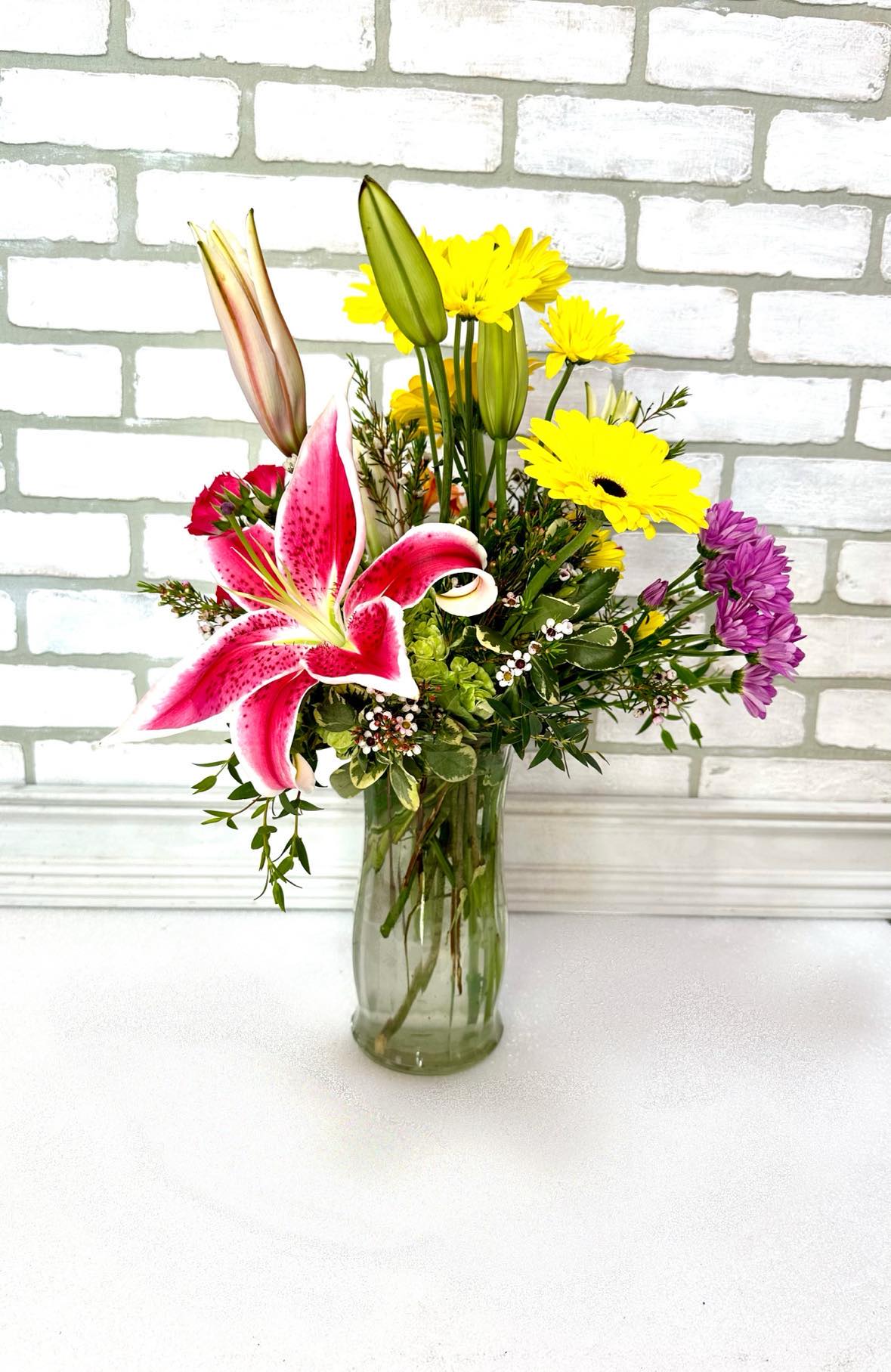 Blissful Blooms - Bringing the garden inside with these fragrant Stargazer lilies paired with hydrangeas, daisies and gerbera daisies. All guaranteed to bring color to any room and put a smile on their face.