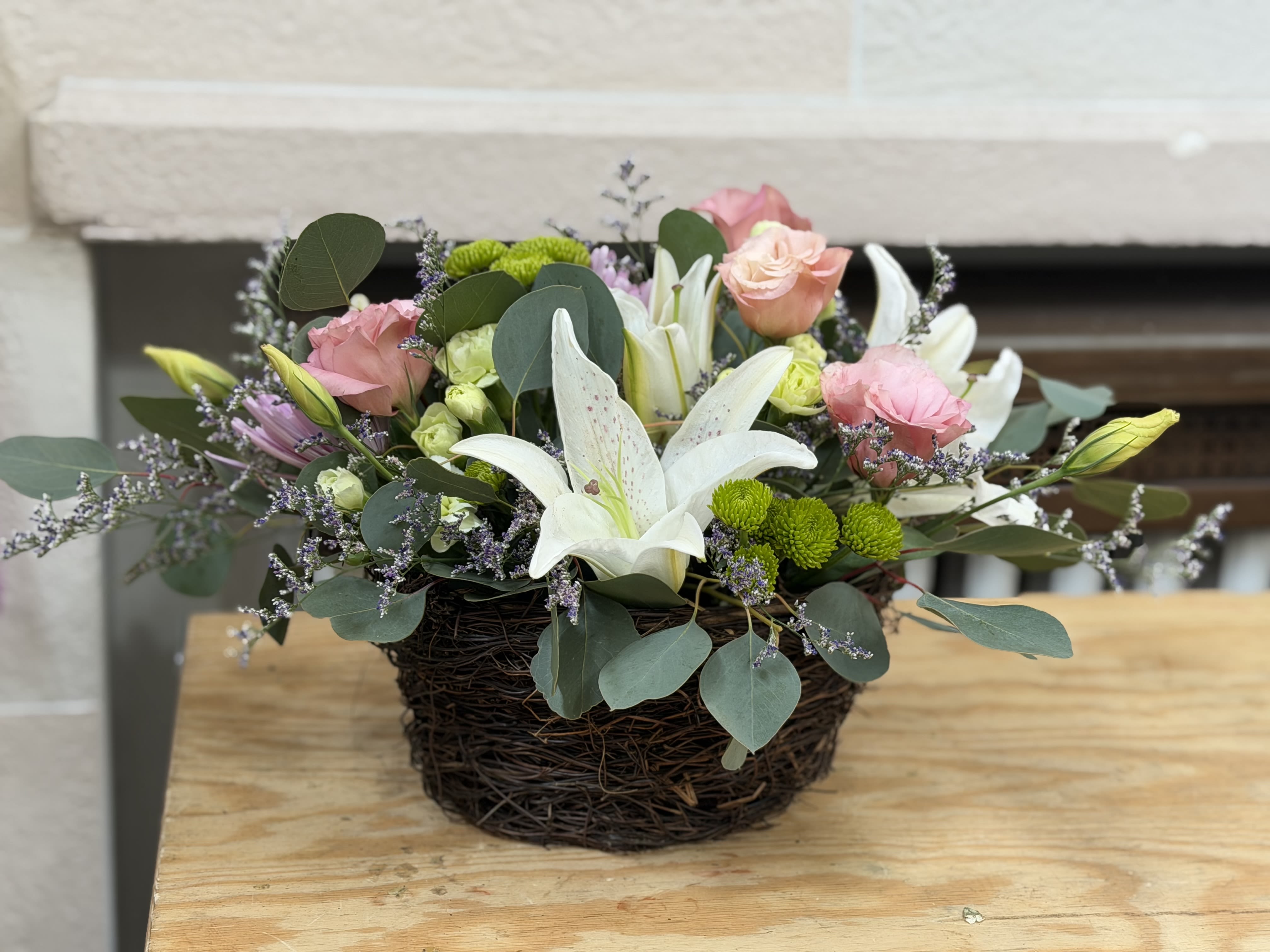 Spring Nest Centerpiece  - A nest style container filled with fresh Easter blooms. 