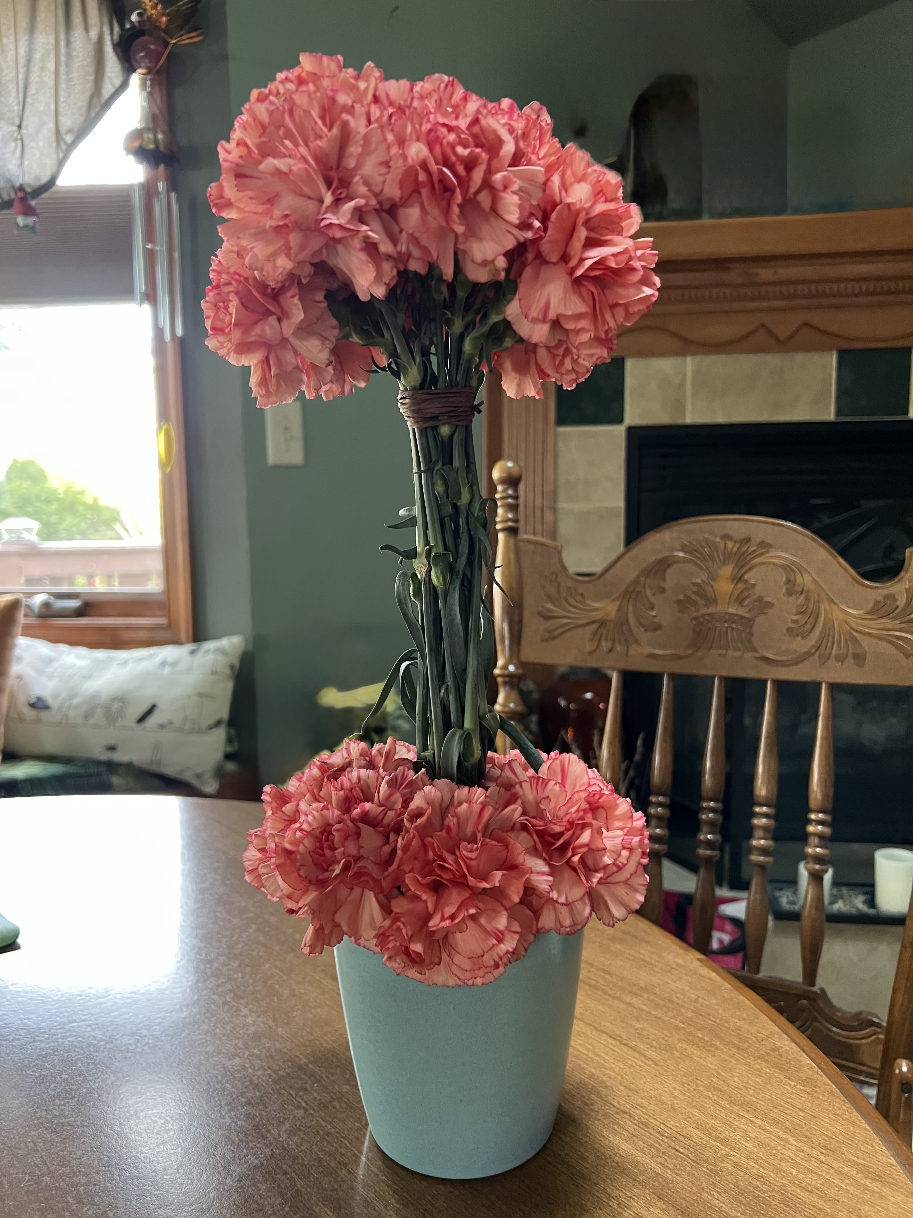 Carnation Topiary - Our deluxe choice will add additional flowers to the bouquet. Inter-dispersed between the lower carnations.