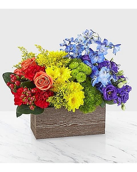 Color Of Love - This bouquet is all about capturing the color of your unique love. With a rainbow color pallete, this arrangement has everything from bold reds to vibrant violets, and the all gorgeous hues in between! Our Color of Love Bouquet is made up of a wide array of blooming beauties like carnations, roses, button pompons and more.  