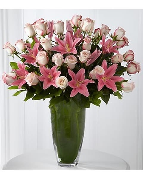 Exquisite Luxury Bouquet - Grant them the ultimate indulgence with a blushing bouquet of beauteous and bountiful blooms. Our finest pale pink 24-inch premium long-stemmed roses are graceful and gorgeously elegant offset by the brilliance of pink Asiatic Lilies, all lovingly situated in a unique and superior 14-inch clear glass tapered bullet vase to delight and dazzle. 