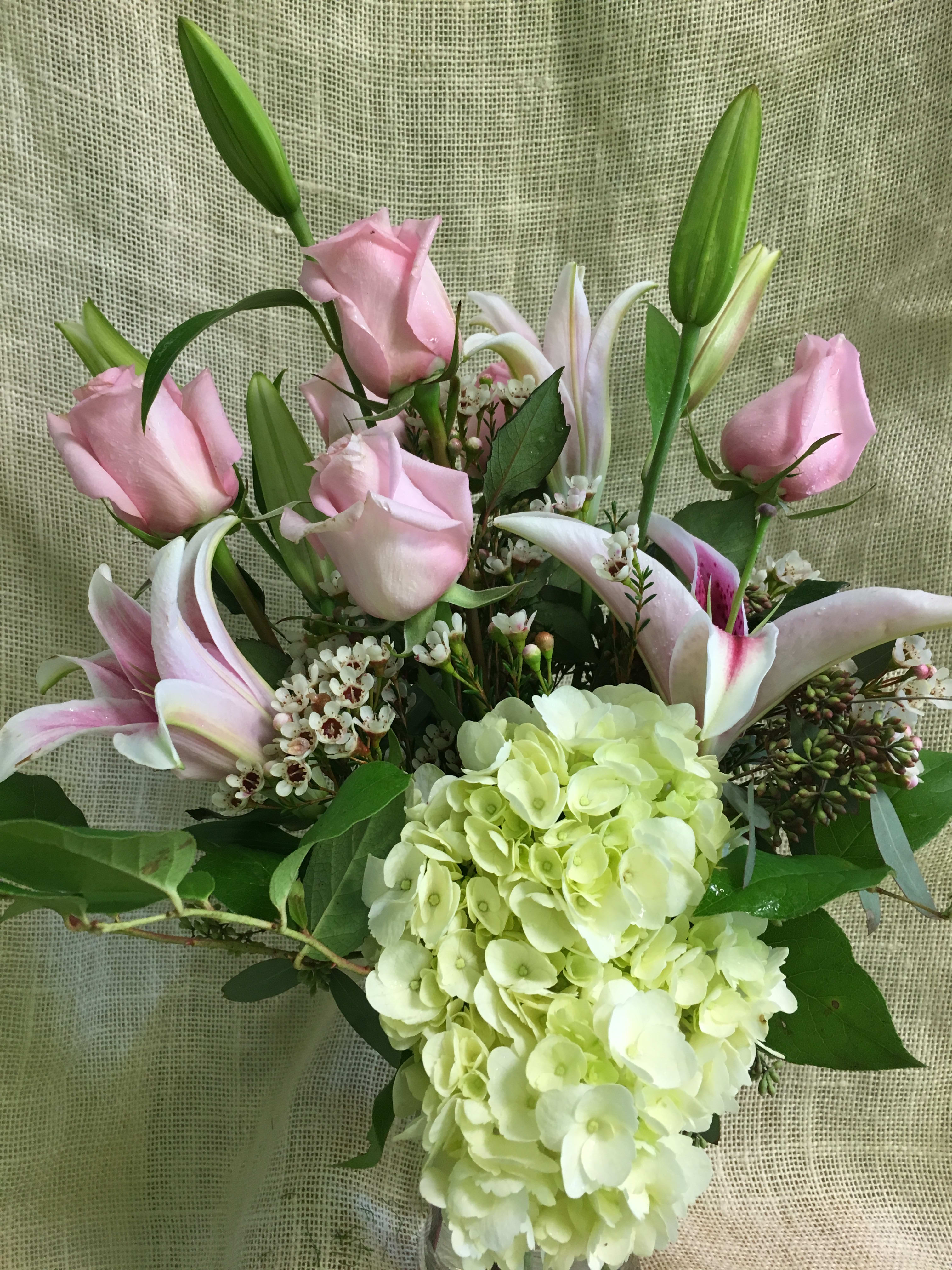 Forever yours - Lilies, Hydrangeas and Roses -  This beautiful arrangement of Lilies, roses and hydrangeas shows your adoration and appreciation of your mom or special friend.   Give this gorgeous bouquet as a demonstration of your love for all she's done for you.   The shade of pink may vary and the lily variety may be slightly different.  We custom create each piece based on availability and seasonality of flowers, and want each arrangement to be one of a kind. Rest assured- your arrangement will have the look and feel you've chosen. Please feel free to leave comments for the designer you would like us to take into account in designing your unique arrangement.