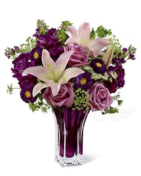Garden Terrace - Garden Terrace™ Bouquet by Vera Wang. You'll understand why the world flocks to Vera Wang for her singular interpretation of romance when you send this bouquet that gorgeously evokes the purple shadows of springtime twilight. Lovely lavender roses, pink LA Hybrid Lilies, fragrant purple gilly flowers, purple matsumoto asters and Queen Anne's Lace accented with lush greens are presented in a sparkling, heavy purple glass heirloom quality vase. Perfect for a spring birthday, Easter, or to celebrate any special occasion any time through the year. 