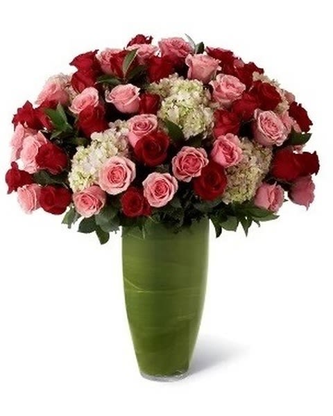 Indulgent Luxury - Let your heart speak through a dazzling display of blooming beauty. 48 Stems of our finest 24-inch premium long-stem roses in blushing shades of pink and red are offset by clouds of soft pink hydrangea, situated in a superior clear glass 14-inch bullet vase, to indulge their every sense.  