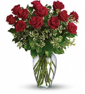 Arrangement of long-stemmed red roses in a clear glass vase