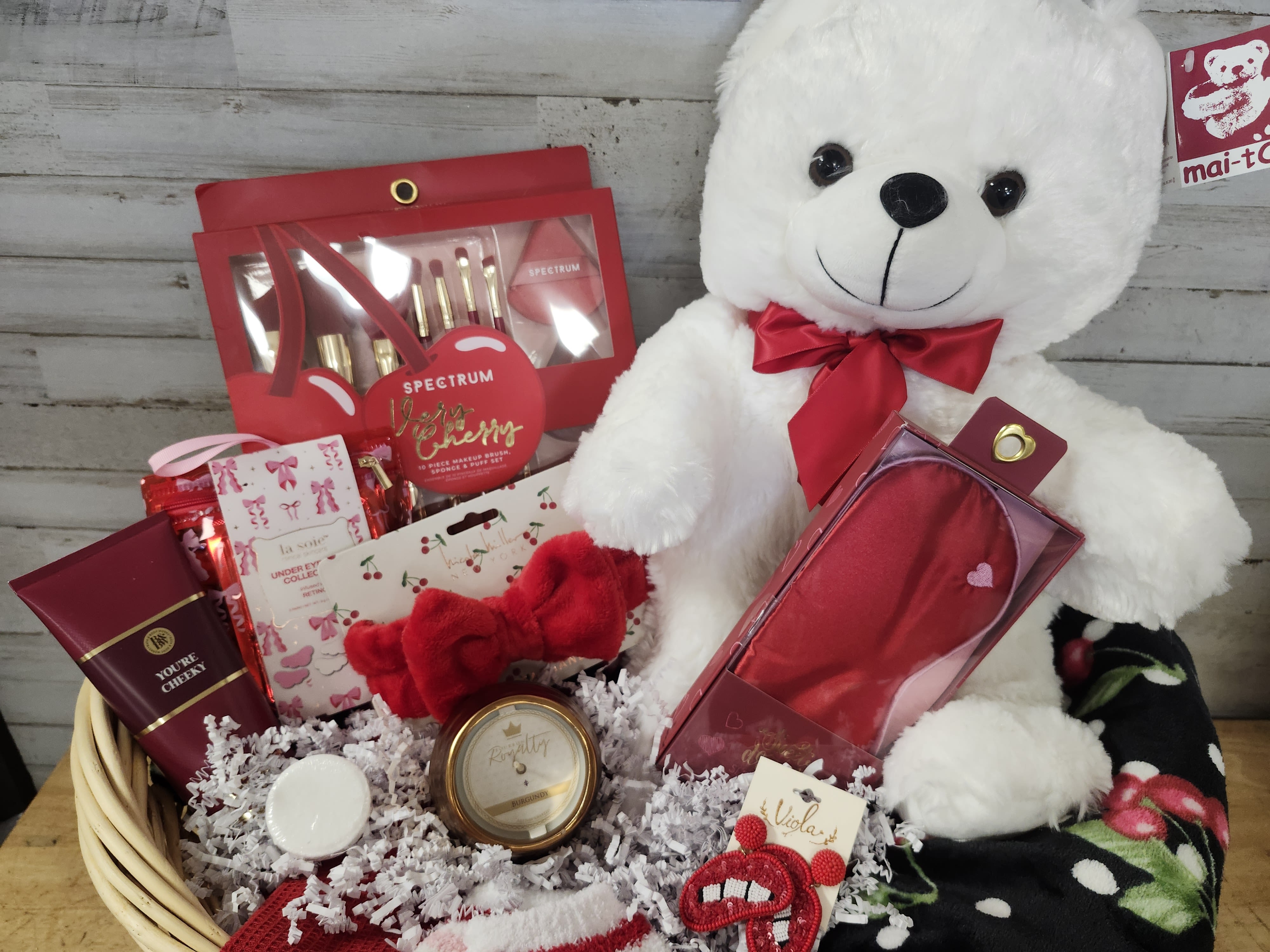 Cherry on Top - $215 - This gift basket is just the Cherry on Top to any celebration.   This gift basket contains: - Super Soft Throw Blanket - Hand Towel - Makeup Brush Set (7 Brush, Sponge, &amp; Puff) - Satin Face Mask - Plush Makeup Headband - Undereye Mask Set - "You're Cheeky" - Body Cream - Bourbon Royalty - Burgundy - Midas Candle - Shower Fizz - Plush Socks - Beaded Earrings - Lips - Delivered in an oversized blanket basket 