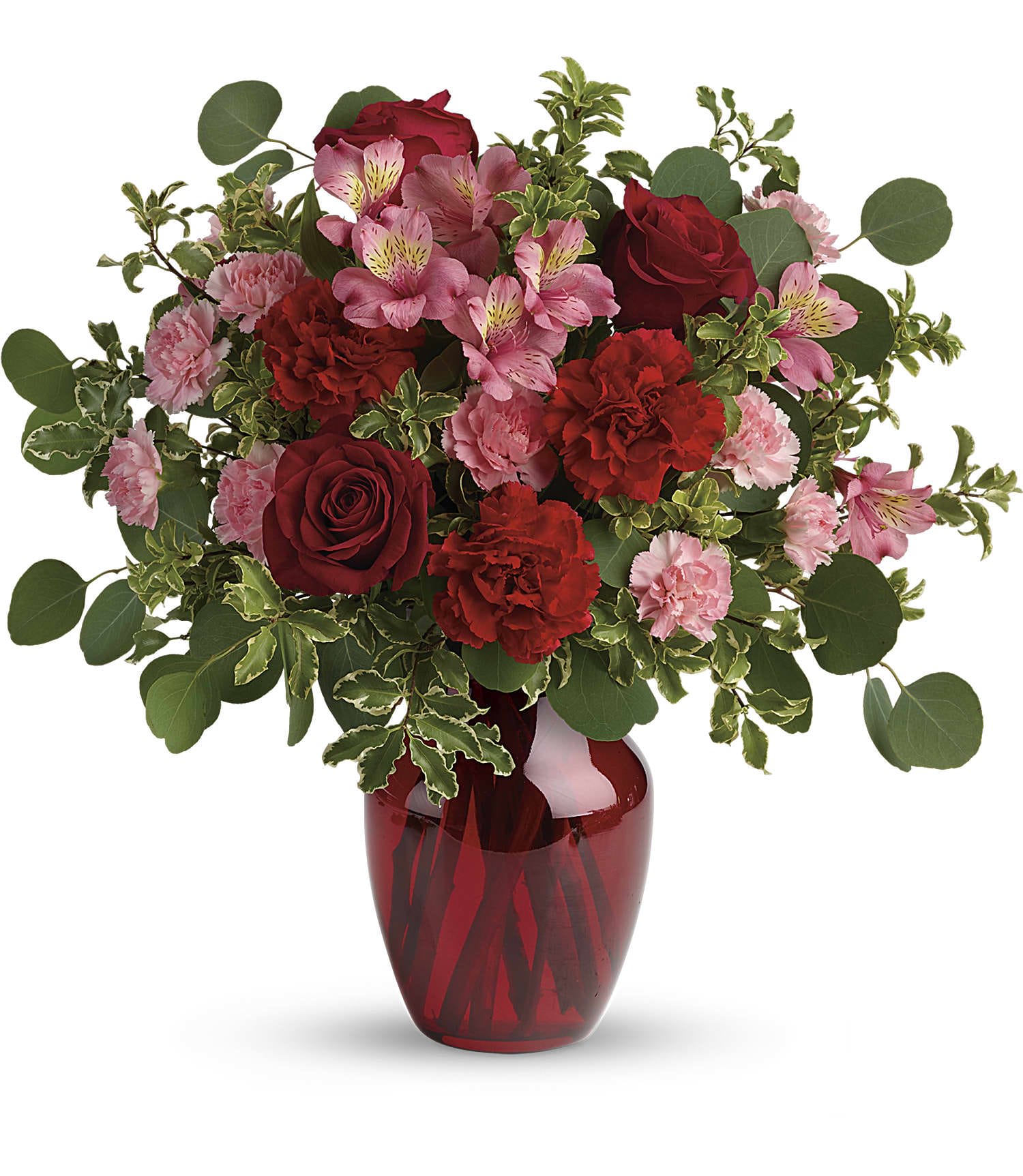 Red and pink roses, carnations, and alstroemeria arranged in a red glass vase
