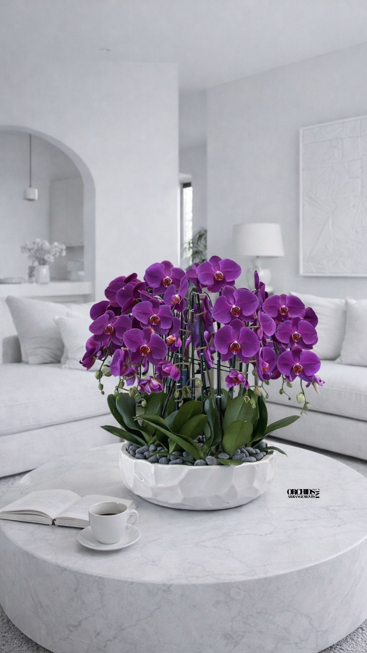 Purple orchid arrangement in a white bowl on a round table