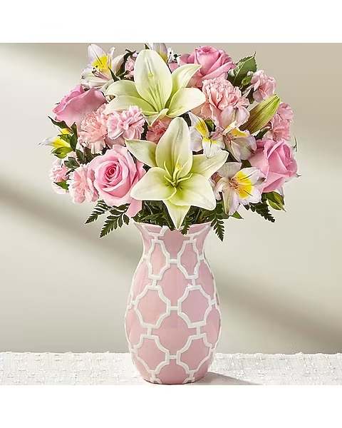 Perfect Pink - Sweet, stylish and ready to make your recipient's day, this blushing bouquet is a gift of love and appreciation they will never forget! Pink roses, carnations, and mini carnations delight the senses, offset by white Asiatic Lilies and Peruvian lilies to create an alluring arrangement. Presented in a keepsake pink ceramic vase embossed with an attractive white modern trellis pattern to add even further interest to this already stunning design, this gorgeous flower arrangement is ready to express your warmest wishes in honor of Mother's Day, a birthday, or as a way to simply say thank you. 