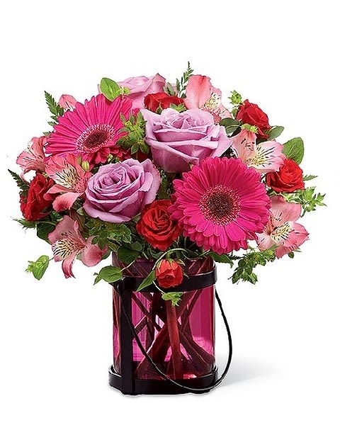 Pink Exuberance - Better Homes and Gardens® Pink Exuberance™ Bouquet. Keep mom "in the pink" this Mother's Day with a stylish bouquet that makes an inspired use of this bright, beautiful and beloved hue. Lavender roses, hot pink Peruvian Lilies, fuchsia gerbera daisies, red spray roses and lush greens are arranged beautifully in a berry-colored glass vase with a black metal holder that can be used later, as a candleholder. 