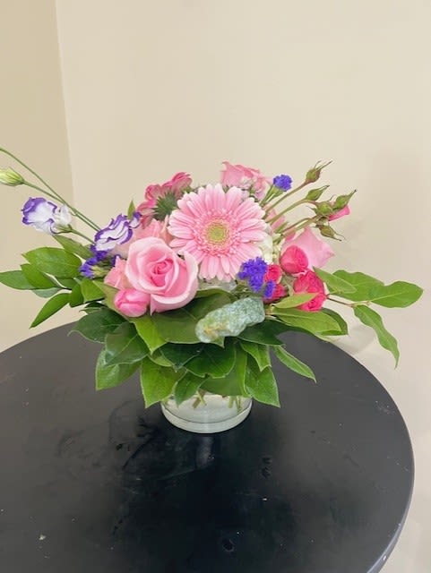 Spring Blossom  - An assortment of beautiful, bright colored blossoms meticulously arranged in a clear glass vase.