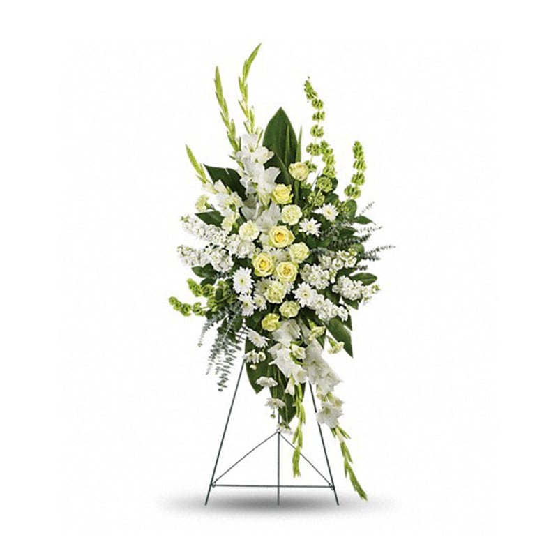 Tall white and pale yellow standing flower spray with roses and mums on a metal easel
