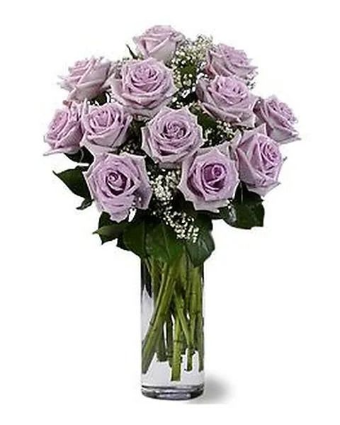Dozen Lavender Roses - One dozen lush lavender roses arrive in an elegant clear glass vase. 