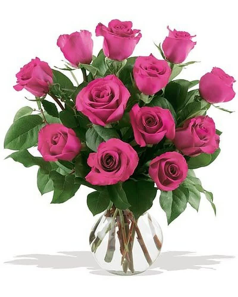 Bouquet of bright pink roses arranged in a round clear glass vase