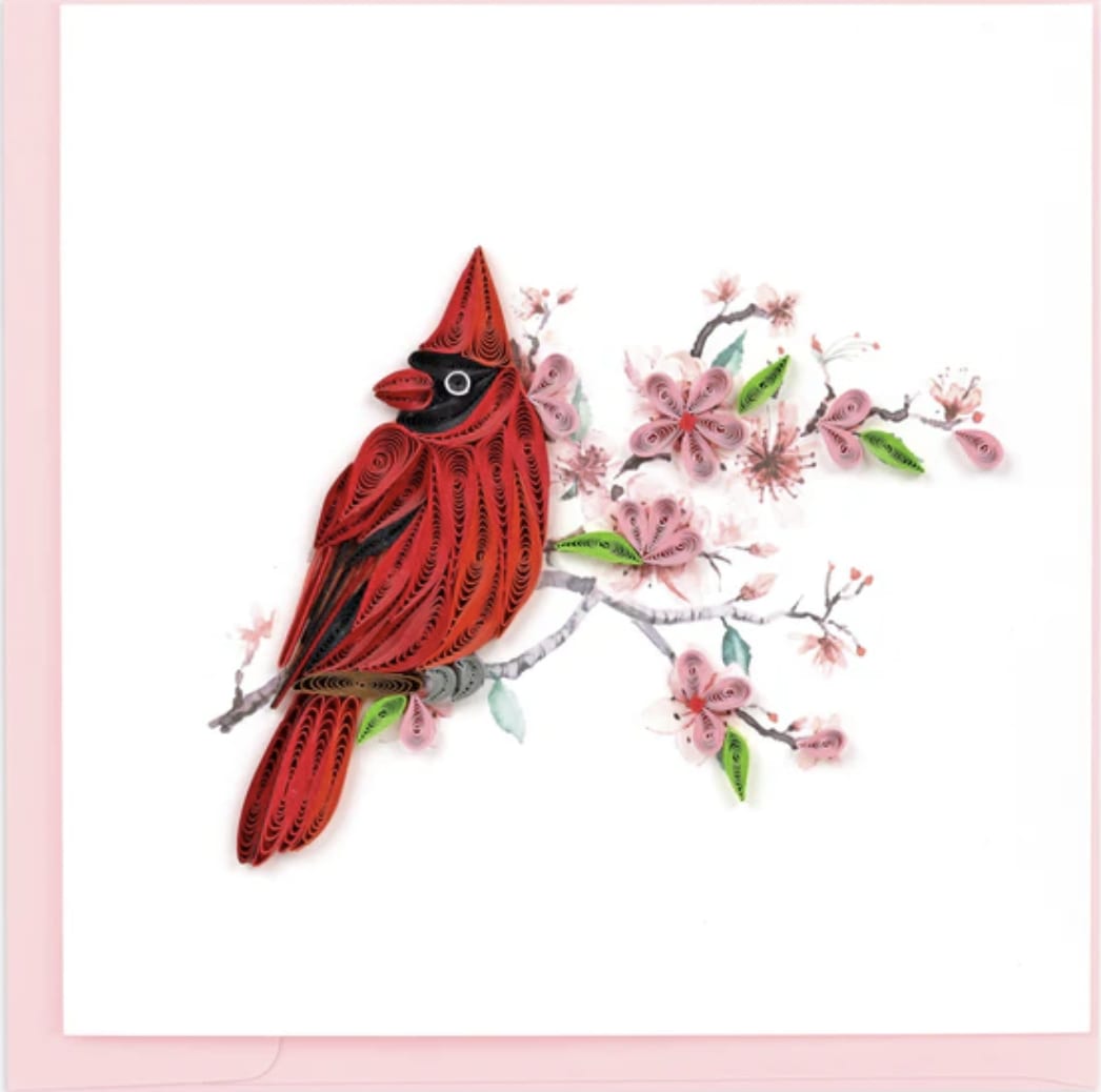 Quilled paper cardinal perched on a branch of pink blossoms on a white greeting card