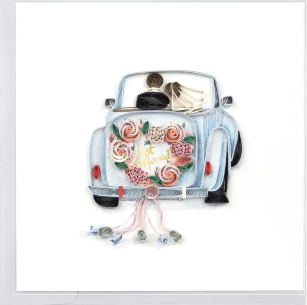 Paper-quilled Just Married car with pastel floral heart and trailing cans on a white greeting card.