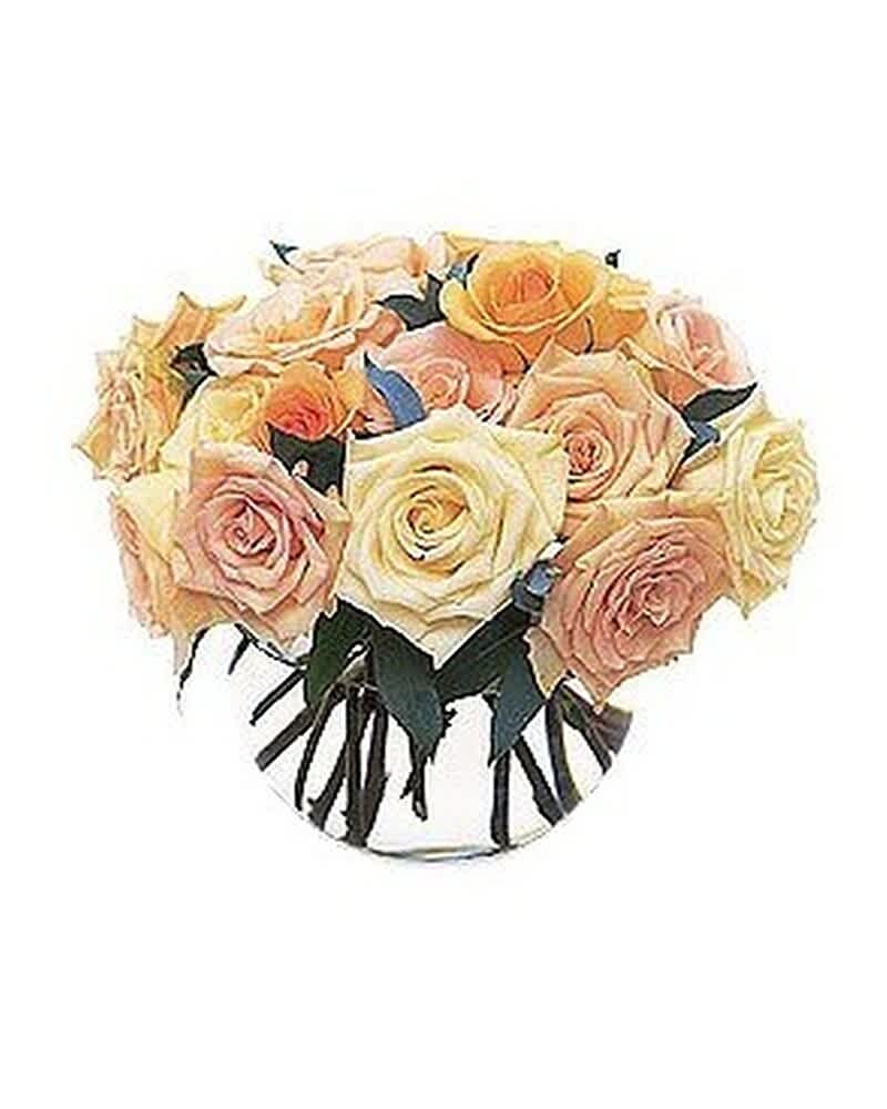 Round glass bowl filled with tightly clustered cream, peach, and yellow roses.