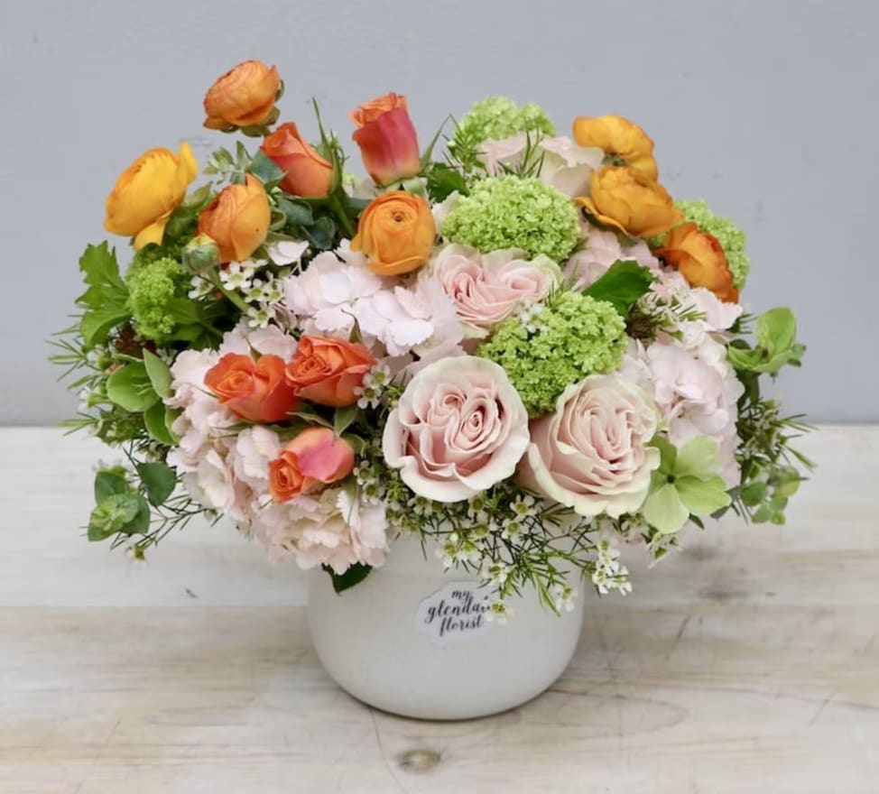 Sun-Kissed Citrus - Weho  - Roses, orange ranunculus, and spray roses make up this arrangement.
