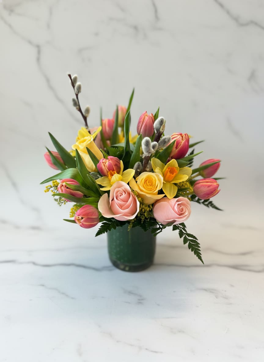 Spring Sunrise  - A bright and cheerful mix of blush roses, golden daffodills and fresh tulips with soft pussy willow captures the joy of a spring morning in full bloom. 