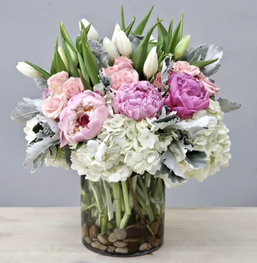 Tulip, Peony, And Rose - WeHo  - Tulips, peonies, roses, baby roses, veronicas, hydrangeas, and dusty miller leaves make this multilayer beauty. If you have a passion for flowers or know someone that does, this is the arrangement for them.