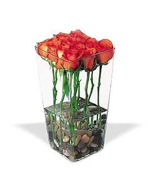 Orange Roses with River Rocks - Stunning, elegant and extraordinary, perhaps very much like that special someone you know. A minimum of 4 days is required to secure this item  