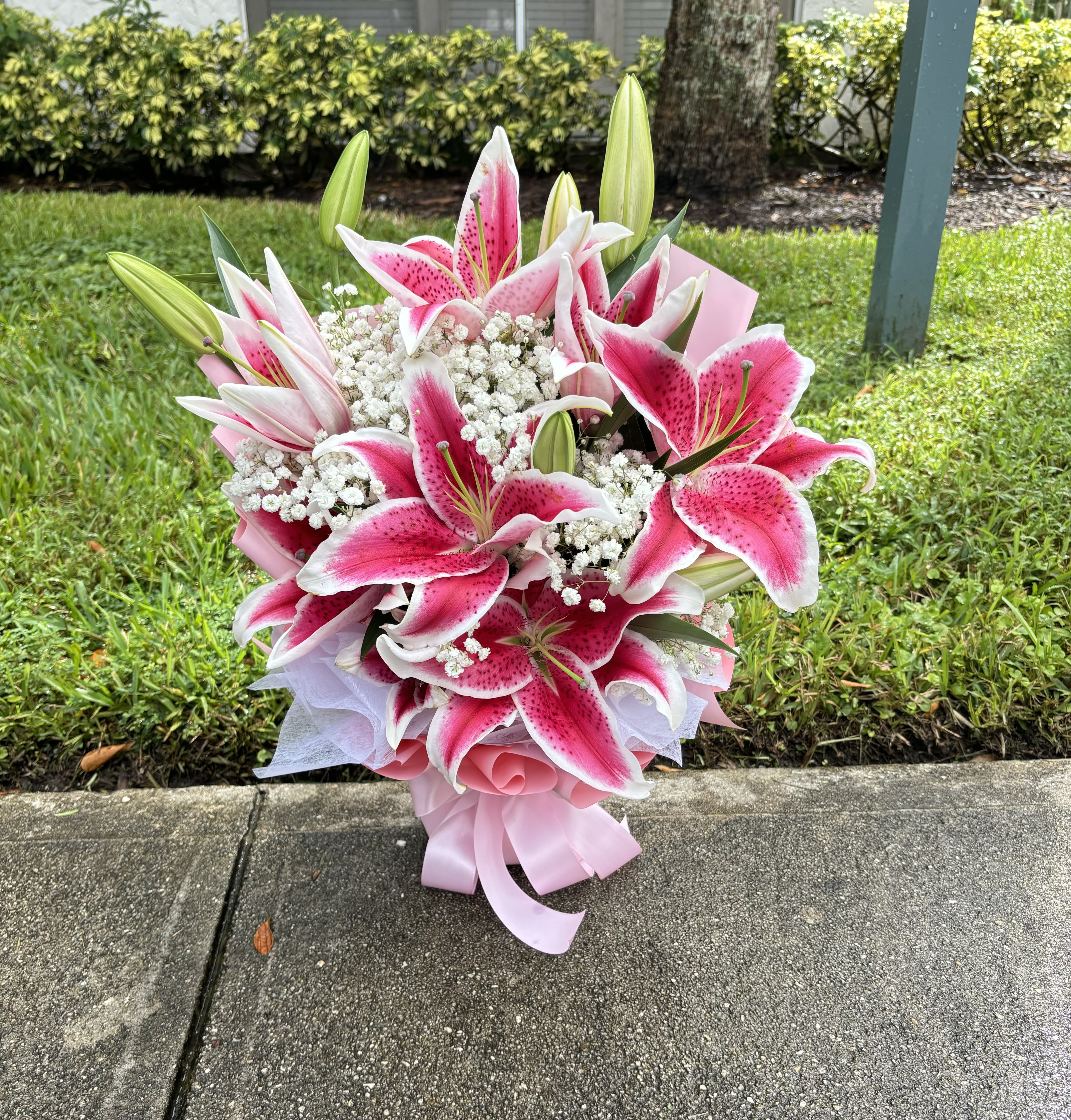 Pink and white lily bouquet with baby's breath and ribbon wrap