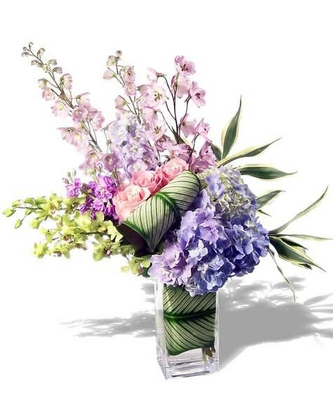 Admirations - An abundance of the most beautiful fresh flowers creating a lush pastel floral fantasy when presented. Send this lavish and upscale floral arrangement to someone amazing, and take their breath away. 