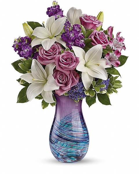 Artful Elegance Bouquet - An elegant expression of your unconditional love! Show her how much you care with this stunning bouquet of roses and lilies, hand-delivered in a breathtaking hand-blown art-glass vase. Crafted in the tradition of fine Venetian glass, this unique art piece swirls with color and is sure to be a treasured décor piece for years to come. 