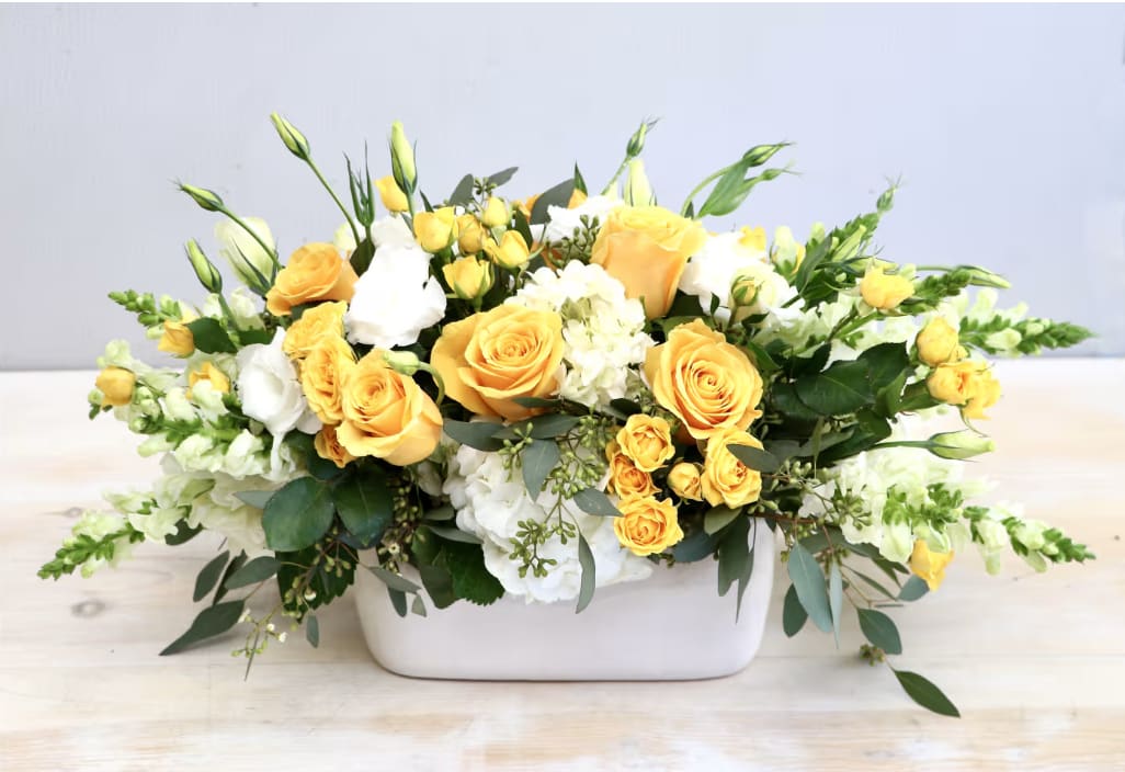 Gold Garden - WeHo  - A white and yellow flower arrangement conveys a sense of purity, serenity, and hope. Brought together with roses, hydrangeas, snapdragons and seasonal greens.