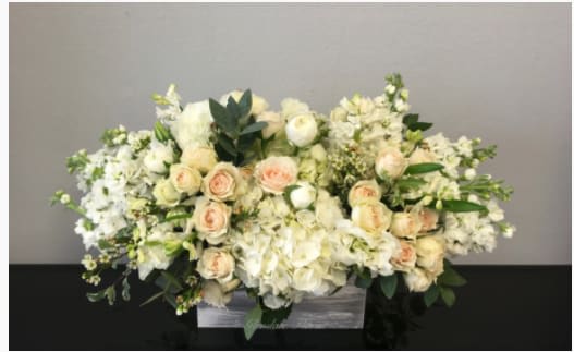 Low white and blush rose and hydrangea arrangement in a rectangular wooden box