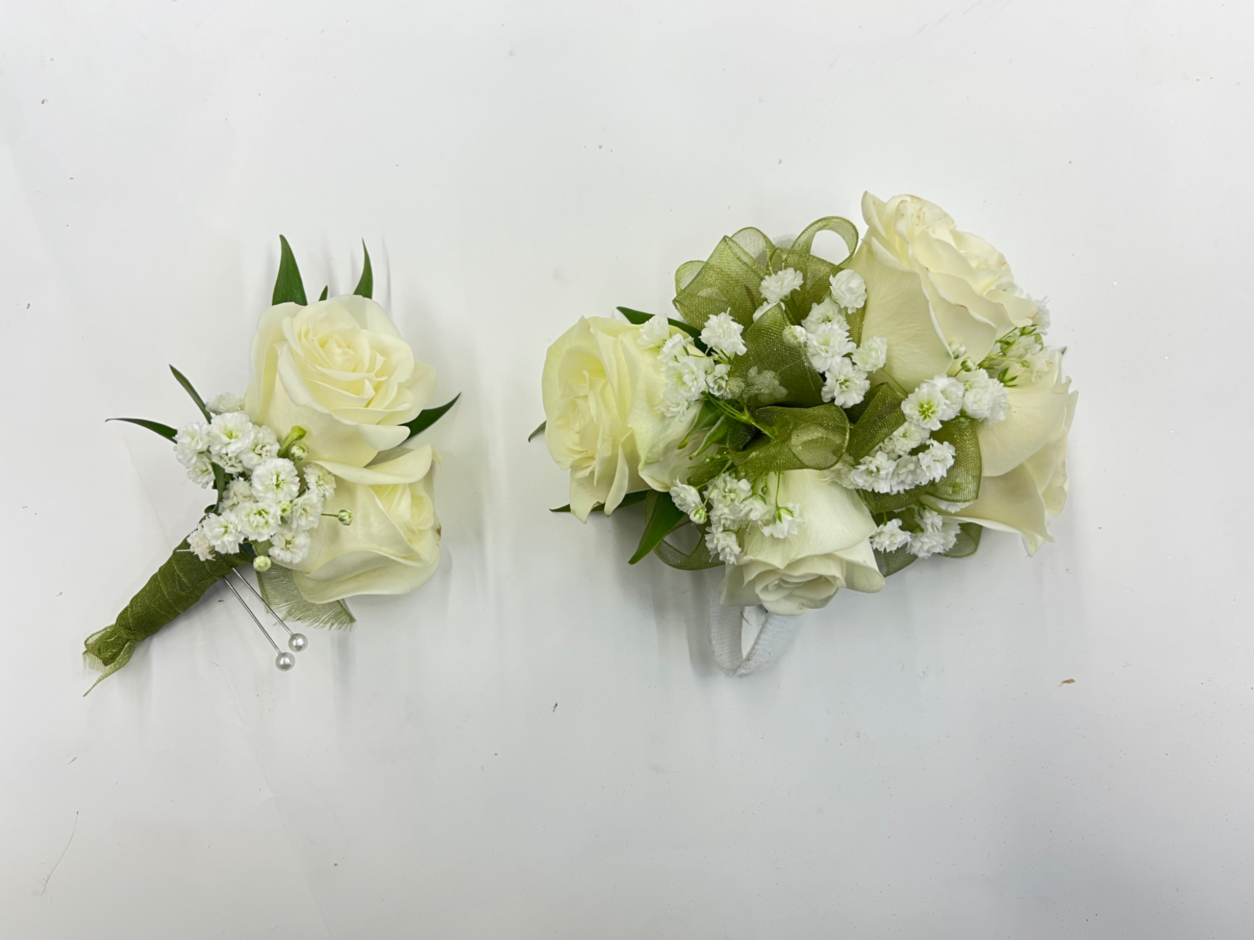 White Rose Corsage &amp; Boutonnière  - White rose corsage and boutonniere set accented with baby’s breath for a soft, classic look. The corsage comes on an adjustable Velcro wristlet, and the boutonniere is attached with a magnet for easy wear. Ribbon color is customizable, please add your choice in the special instructions.