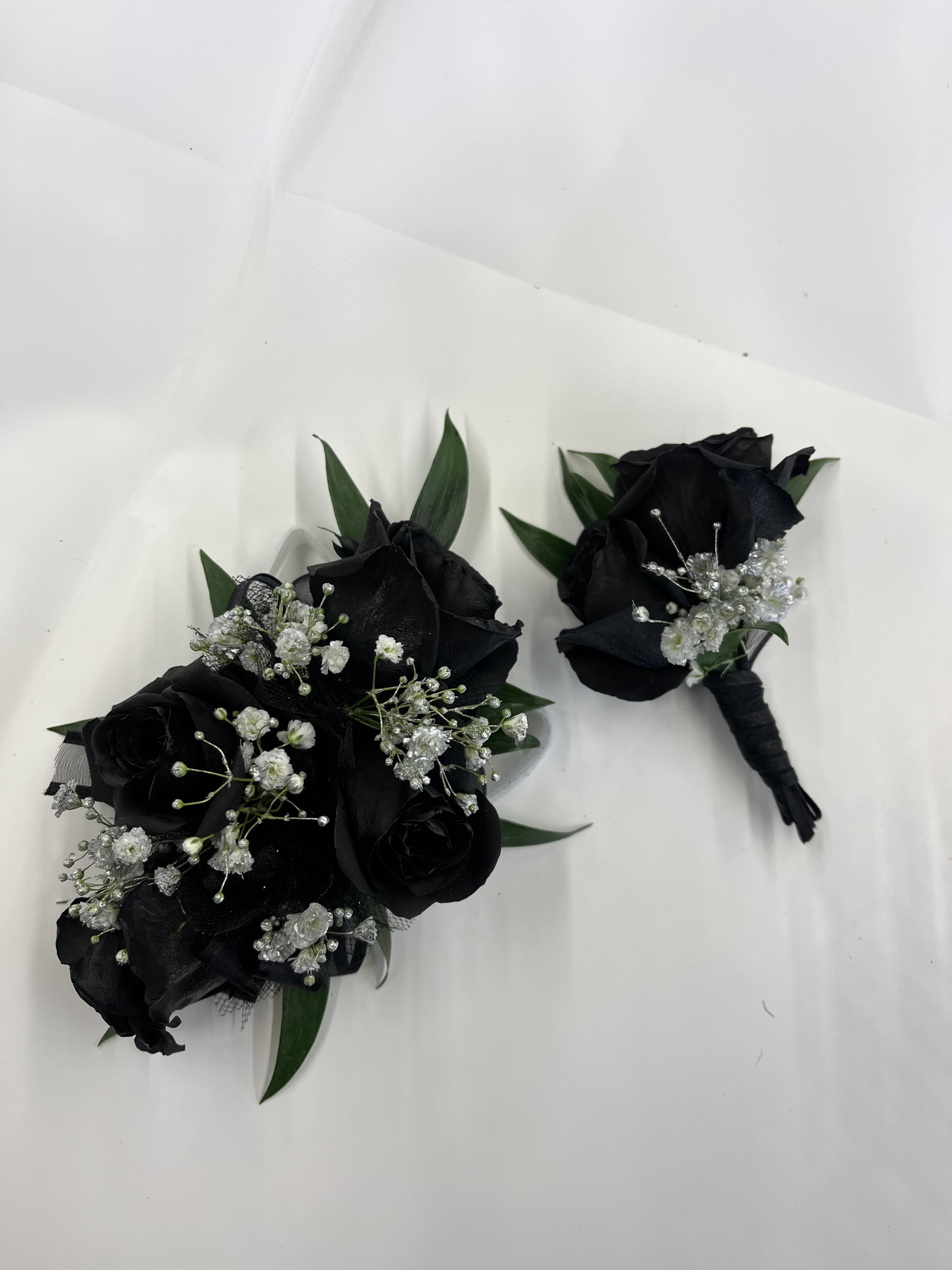 Black Rose Corsage &amp; Boutonnière  - Black rose corsage and boutonniere set for a bold, modern look, accented with baby breath. The corsage comes on an adjustable Velcro wristlet, and the boutonniere is attached with a magnet for easy wear. Ribbon color is customizable, please add your choice in the special instructions.