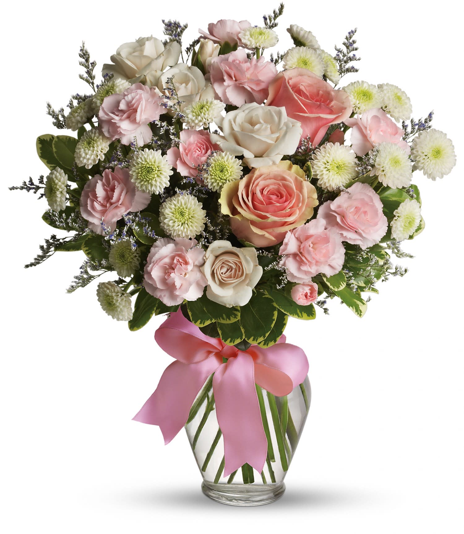 Pink and white roses, carnations, and white mums in a clear glass vase with a pink ribbon bow