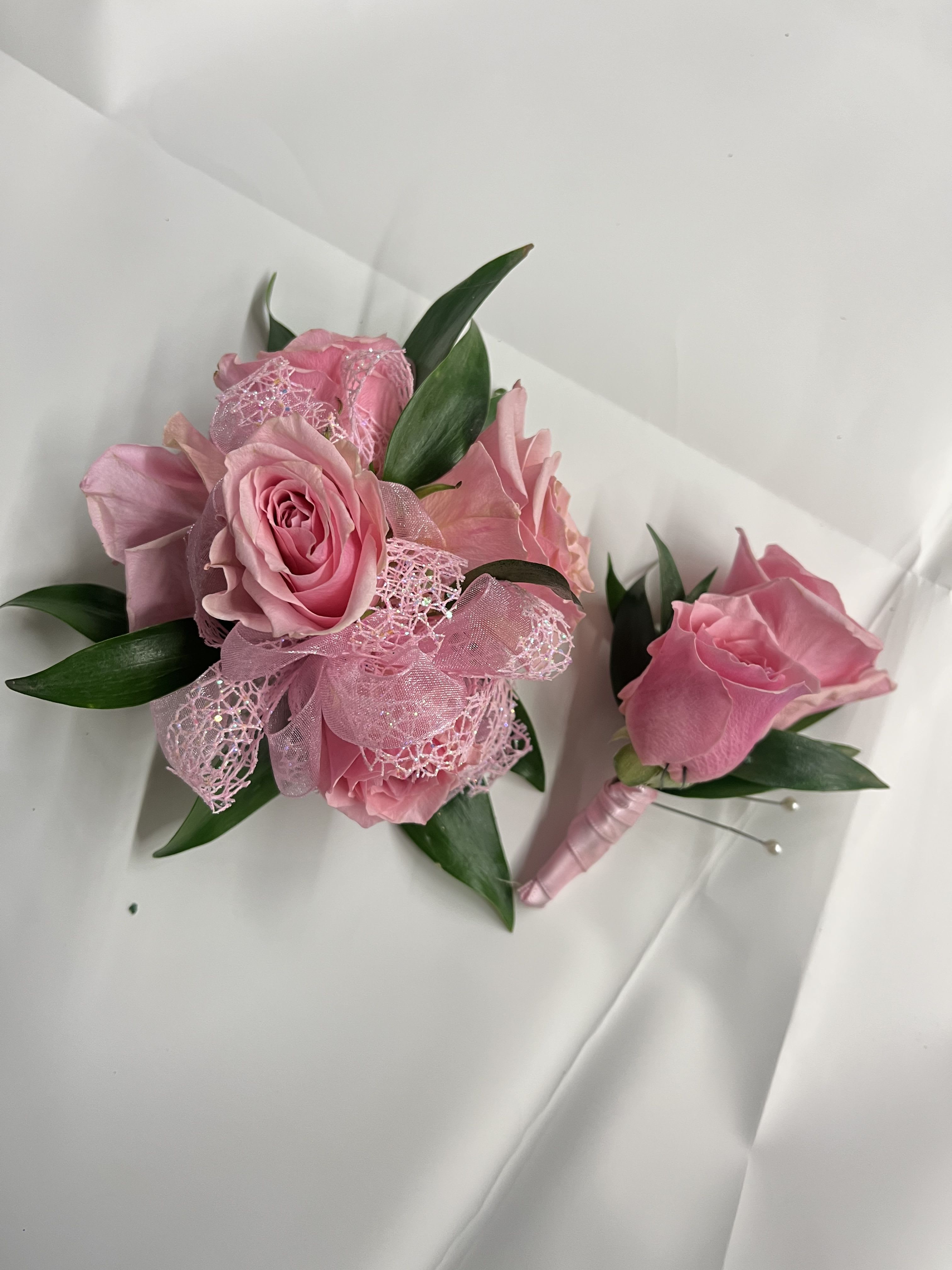 Pink Rose Corsage &amp; Boutonnière  - Pink rose corsage and boutonniere set for a soft, romantic look. The corsage comes on an adjustable Velcro wristlet, and the boutonniere is attaches with a magnet for easy wear. Ribbon color is customizable, please add your choice in the special instructions. Baby’s breath can be added upon request, just include it in your notes.