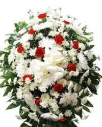 Classic Tribute Standing Spray - A timeless and elegant standing spray designed to honor and remember a loved one. This heartfelt arrangement features white mums, white spider mums, and red carnations, beautifully accented with fresh greenery and finished with a white ribbon bow.  The combination of white and red blooms symbolizes love, respect, and remembrance, making this spray a dignified and comforting tribute for funerals or memorial services.